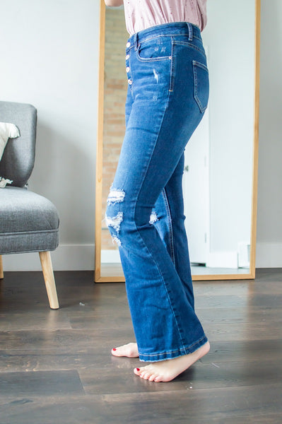Side view of model wearing flare jeans.