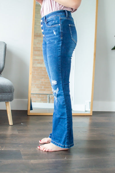 Side view of model wearing flare jeans.